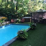 Luxury grass softens around pool and concrete