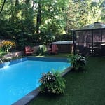 Luxury grass softens around pool and concrete