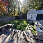 Cedar deck paver path bordered with grass