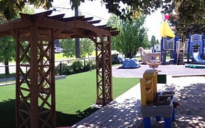 Oshawa daycare with artificial grass providing clean soft surface for kids playing 