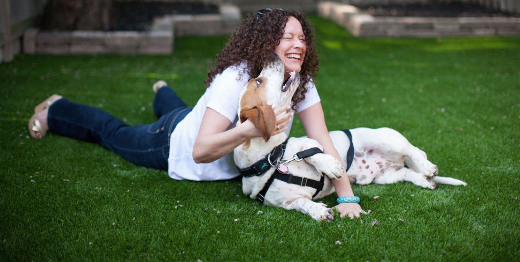 happy-dog-with-owner-artificial-grass